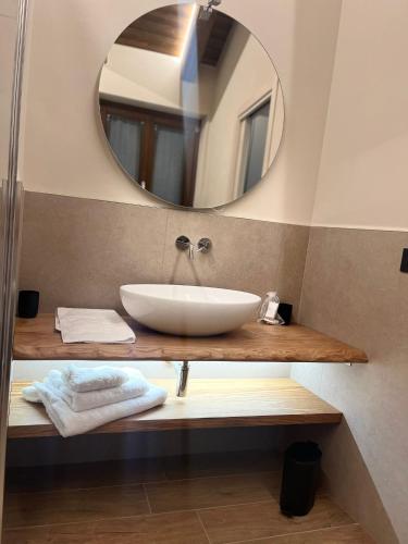 a bathroom with a sink and a mirror at La Porta delle Meraviglie in Saluzzo