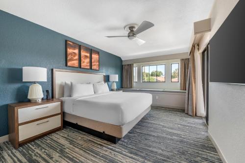 a bedroom with a large bed and a window at Orbit One Vacation Villas in Orlando