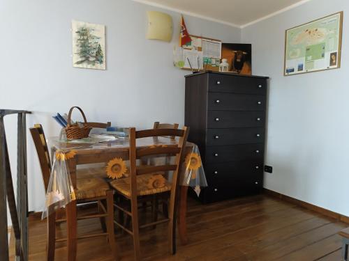 a dining room with a table and chairs and a black dresser at B&B Abies in Polizzi Generosa