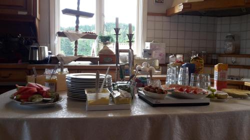 a table with bowls of food on it in a kitchen at Älgbergets Bed & Breakfast in Ucklum