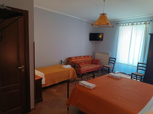 a living room with two beds and a couch at B&B Abies in Polizzi Generosa