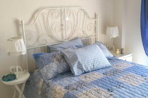 a bed with a white headboard and pillows on it at 2 Bed-Sleeps4-Garden-Parking-Pets-AirCon in Nikiti