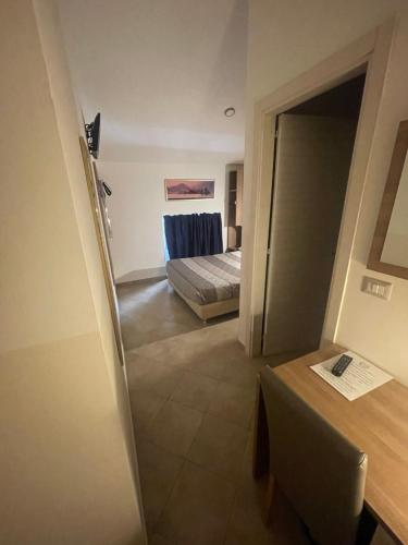 a room with a bedroom with a bed and a table at Hotel Montecarlo in Milan