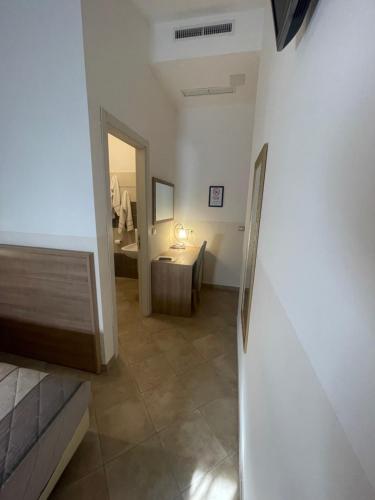 a room with a bathroom with a sink and a mirror at Hotel Montecarlo in Milan