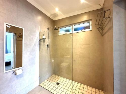 a bathroom with a shower with a glass door at One bedroom Apartment in Hout Bay
