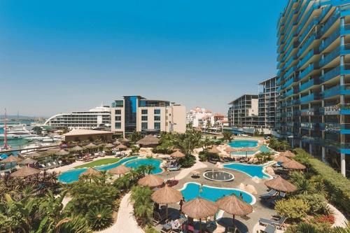 an aerial view of a resort with pools and umbrellas at 2 Bed Apt in Ocean Village - Pool - Rock View - Sleeps 4 in Gibraltar
