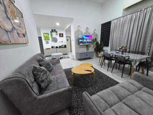 a living room with a couch and a table at Homestay DAR AL - JUFRY in Kuantan