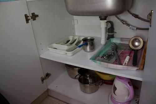 a kitchen shelf with a sink and a sink at Xi Village in Xi