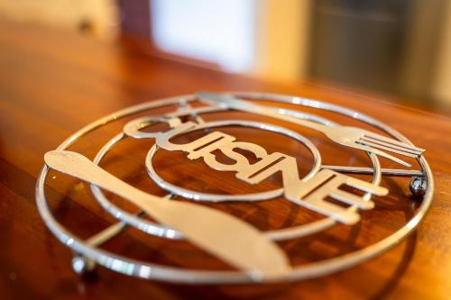 a plate with fork and knife on a wooden table at Duplex terrasse avec belle vue in Fort-de-France