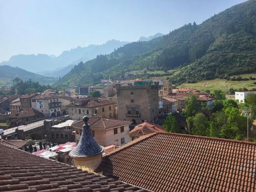 a view of a town with mountains in the background at El mirador de la torre in Potes
