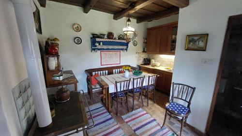 a kitchen with a dining room table and chairs at Berényi apartman in Erdőhorváti