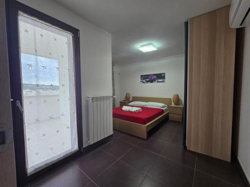 a small bedroom with a bed and a window at Villa Teresa in Leuca