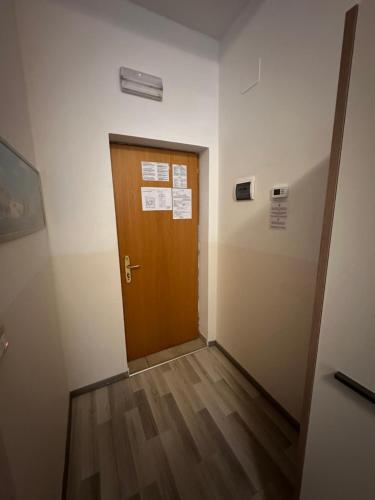 a hallway with a wooden door in a room at Hotel Montecarlo in Milan