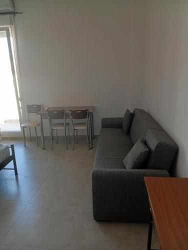 a living room with a couch and a table at ChiosRoomsEirini in Chios