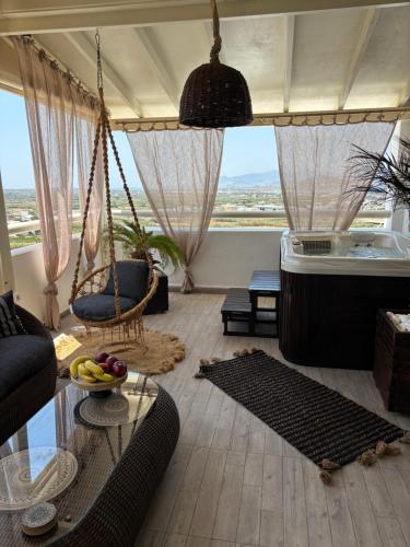 a living room with a hanging couch and a table at Black Velvet in Agkidia