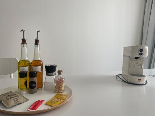 a counter with bottles of alcohol and a coffee maker at "Rose" Atypique, clim, coeur du Quartier Haut in Sète