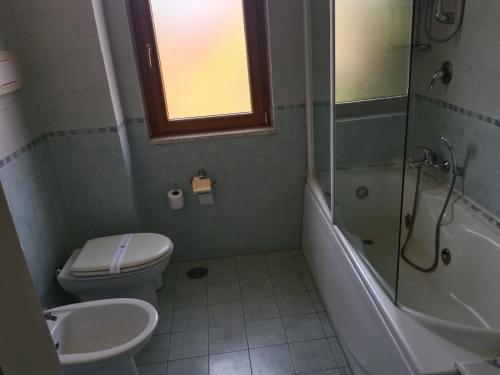a bathroom with a toilet and a shower and a sink at Hotel La Fayette Giugliano Licola in Giugliano in Campania