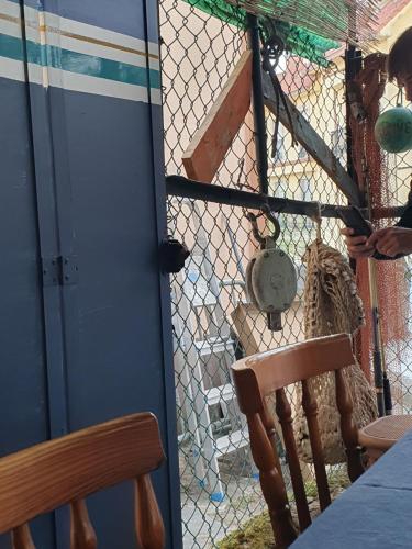 a door with a chain link fence and a chair at Casita en Fontán in Sada