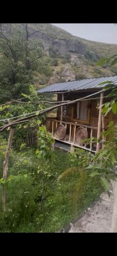 a small building with a roof on top of it at Vardzia Chachkari Cottage in Gogasheni