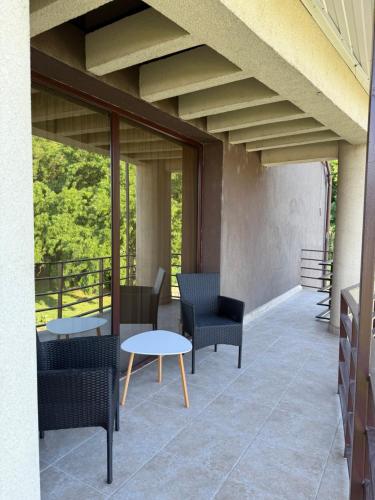 a patio with chairs and tables on a balcony at Vila Premiere Bistro-Spa in Piatra Neamţ