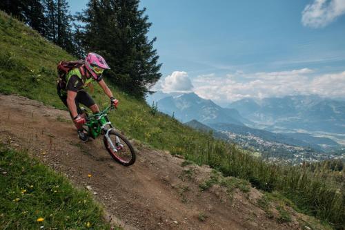 a person riding a bike down a hill at Pauline in Gryon