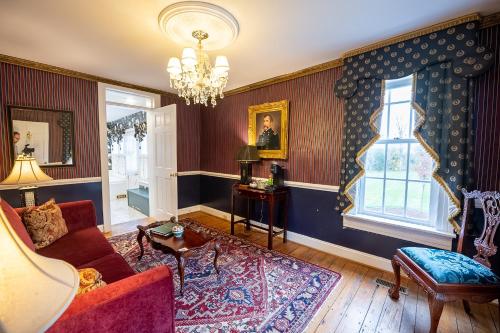 a living room with a couch and a window at Antrim 1844 in Taneytown