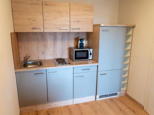 a small kitchen with a sink and a microwave at Apartment Seethurn by Interhome in Strobl