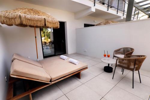 a living room with a couch and a table and chairs at Hotel Santanyi Port in Cala Figuera