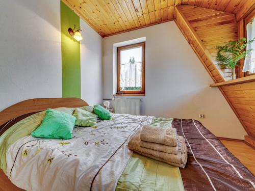 a bedroom with a bed with green walls at Apartment Kotarz View by Interhome in Brenna