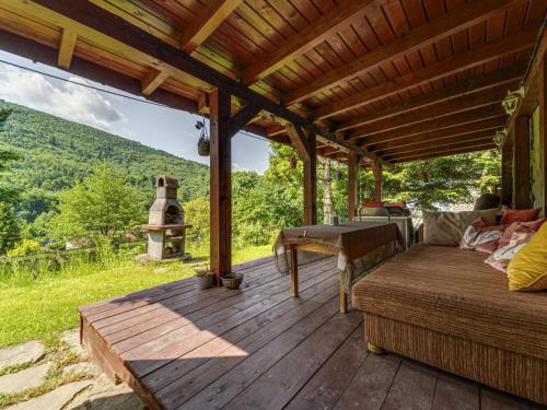 a wooden deck with a bed and a table on it at Apartment Kotarz View by Interhome in Brenna