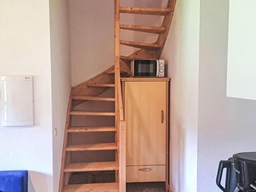 a staircase in a room with a refrigerator at Apartment Kesselboden by Interhome in Grünau im Almtal