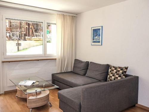 a living room with a couch and a glass table at Apartment Rubin by Interhome in Zermatt