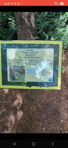a sign that is in front of a tree at Vikendica Grahovo in Nikšić