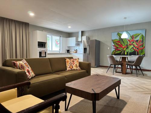 a living room with a couch and a table at Monstera Apartments in Paramaribo