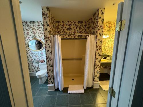 a bathroom with a shower and a toilet in it at Antrim 1844 in Taneytown