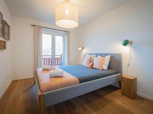 a bedroom with a bed with a large window at Apartment Diolinoir 34 by Interhome in Ovronnaz