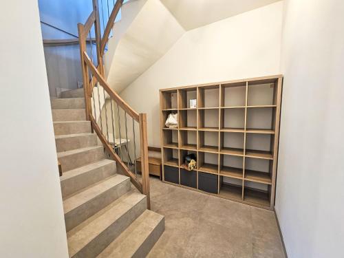 a staircase with a book shelf and a stair case at Chalet Ossiacher See Chalet 2 by Interhome in Bodensdorf