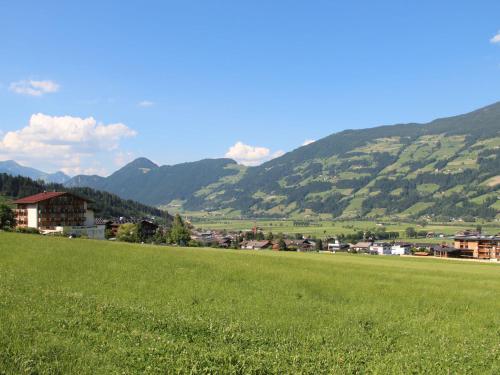 a green field with a town and mountains in the background at Apartment Apartment Söllbacherhof by Interhome in Gagering