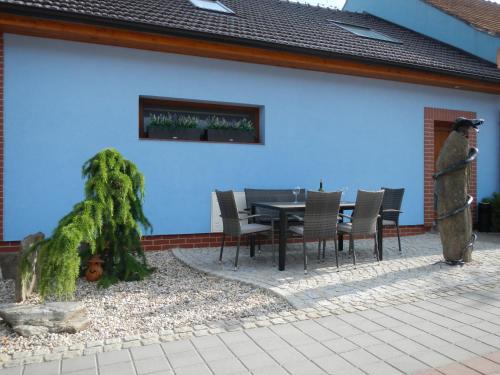 a patio with a table and chairs next to a building at Penzion U Hada in Velké Pavlovice