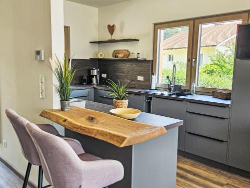 a kitchen with a wooden table and some chairs at Chalet Ossiacher See Chalet 1 by Interhome in Bodensdorf
