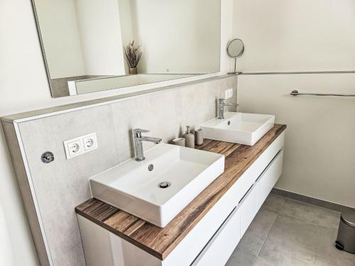 a bathroom with a white sink and a mirror at Chalet Ossiacher See Chalet 1 by Interhome in Bodensdorf