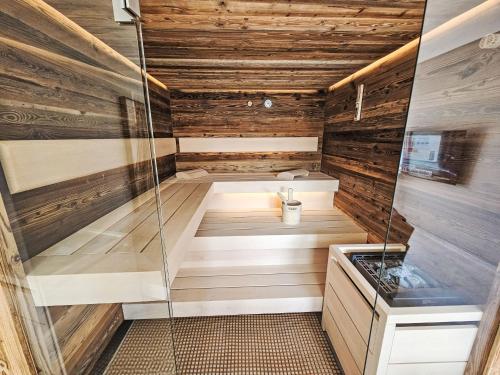 a sauna with wooden walls and a glass floor at Chalet Ossiacher See Chalet 1 by Interhome in Bodensdorf