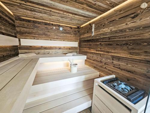 a sauna with wooden walls and a tub at Chalet Ossiacher See Chalet 1 by Interhome in Bodensdorf