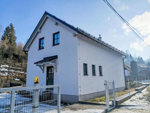 a white house with a fence in front of it at Holiday Home Casa Lenka by Interhome in Zlaté Hory