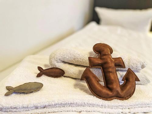 a bed with a towel and an anchor on it at Apartment Fewo 1 in ruhigem Haus by Interhome in Süderende