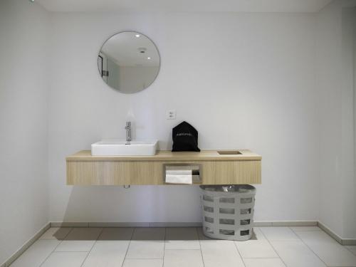 a bathroom with a sink and a mirror at Apartment La Siala Apt-56A by Interhome in Falera