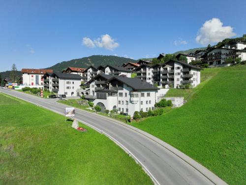 a road in a village with houses on a hill at Apartment La Siala Apt-56A by Interhome in Falera