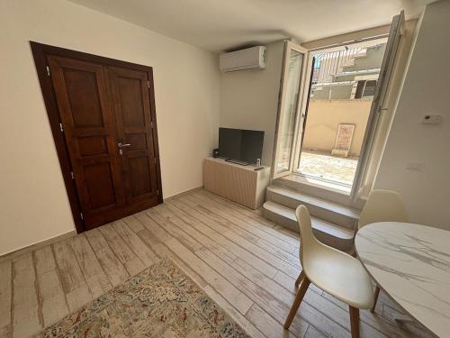 a room with a table and a chair and a door at Casa Annalisa - Pesaro Center in Pesaro