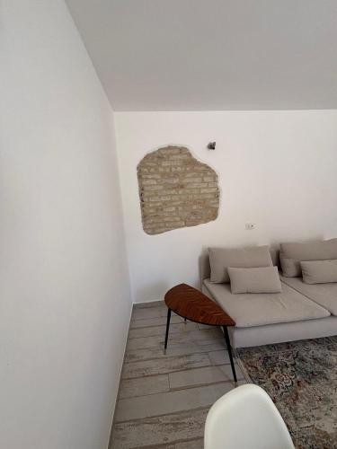 a living room with a couch and a chair at Casa Annalisa - Pesaro Center in Pesaro