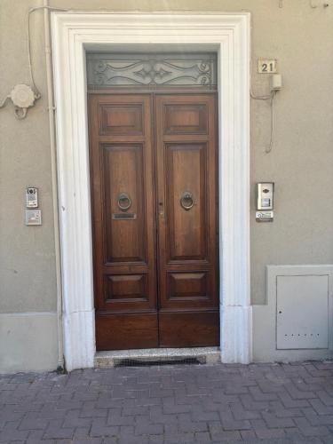 a large wooden door in the side of a building at Casa Annalisa - Pesaro Center in Pesaro